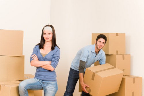 Professional movers preparing furniture for transport near The Burroughs