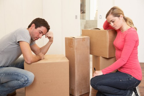 Local removals team handling boxes and furniture with a moving van
