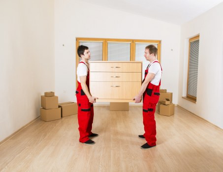Furniture and boxes prepared for transport by a man with van service